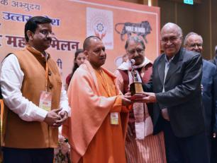 उत्तर प्रदेश के मुख्यमंत्री योगी आदित्यनाथ जी 28 जनवरी, 2018 को लखनऊ में सूक्ष्म एवं लघु उद्यमी महासम्मेलन में एक उद्यमी को सम्मानित करते हुए।