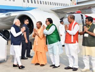 उत्तर प्रदेश के मुख्यमंत्री योगी आदित्यनाथ जी 12 नवम्बर, 2018 को प्रधानमंत्री श्री नरेन्द्र मोदी जी का वाराणसी हवाई अड्डे पर स्वागत करते हुए।